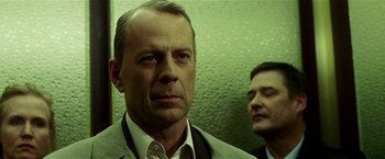 Movie still from “Lucky Number Slevin” (2006), directed by Paul McGuigan – A man in a suit standing next to another man in a suit; Close Up shot, Low angle