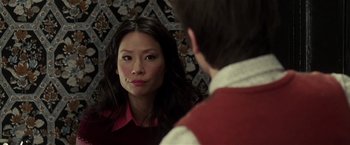 Movie still from “Lucky Number Slevin” (2006), directed by Paul McGuigan – A woman looking in the mirror while a man looks at her face; Close Up shot, Over the shoulder angle