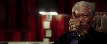 Movie still from “Lucky Number Slevin” (2006), directed by Paul McGuigan – A man sitting in a chair talking on a phone; Close Up shot, Over the shoulder angle