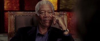 Movie still from “Lucky Number Slevin” (2006), directed by Paul McGuigan – An older man with grey hair is smiling; Close Up shot, Low angle