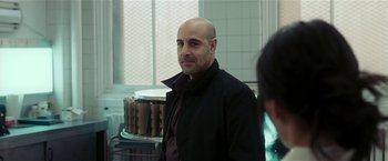 Movie still from “Lucky Number Slevin” (2006), directed by Paul McGuigan – A man in a black jacket standing in a kitchen; Close Up shot, Over the shoulder angle