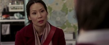 Movie still from “Lucky Number Slevin” (2006), directed by Paul McGuigan – A woman wearing a red jacket and a red scarf; Close Up shot, Over the shoulder angle