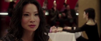 Movie still from “Lucky Number Slevin” (2006), directed by Paul McGuigan – A person sitting at a table; Close Up shot, Over the shoulder angle