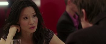 Movie still from “Lucky Number Slevin” (2006), directed by Paul McGuigan – A person sitting at a table; Close Up shot, Over the shoulder angle