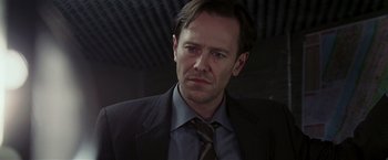 Movie still from “Lucky Number Slevin” (2006), directed by Paul McGuigan – A person wearing a suit and tie; Close Up shot, Low angle