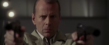 Movie still from “Lucky Number Slevin” (2006), directed by Paul McGuigan – A person wearing a suit and tie; Close Up shot, Low angle