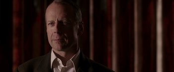 Movie still from “Lucky Number Slevin” (2006), directed by Paul McGuigan – A person wearing a suit and tie; Close Up shot, Over the shoulder angle