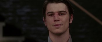 Movie still from “Lucky Number Slevin” (2006), directed by Paul McGuigan – A person wearing a suit and tie; Close Up shot, Over the shoulder angle