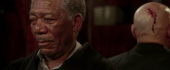 Movie still from “Lucky Number Slevin” (2006), directed by Paul McGuigan – An older man wearing a black jacket and a white shirt; Close Up shot, Over the shoulder angle