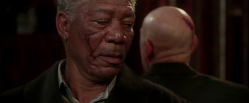 Movie still from “Lucky Number Slevin” (2006), directed by Paul McGuigan – An older man with a scar on his face; Close Up shot, Over the shoulder angle