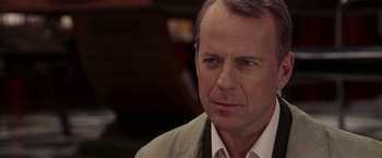 Movie still from “Lucky Number Slevin” (2006), directed by Paul McGuigan – A person wearing a suit and tie; Close Up shot, Over the shoulder angle