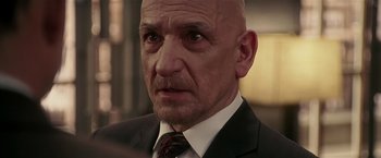 Movie still from “Lucky Number Slevin” (2006), directed by Paul McGuigan – An older man in a suit and tie looking at the camera; Close Up shot, Over the shoulder angle