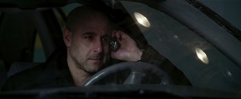 Movie still from “Lucky Number Slevin” (2006), directed by Paul McGuigan – A man talking on a cell phone while sitting in a car; Close Up shot, Over the shoulder angle