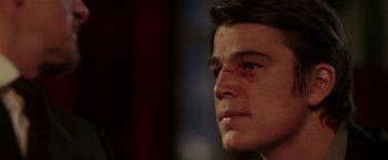 Movie still from “Lucky Number Slevin” (2006), directed by Paul McGuigan – A man's face in a dark room; Close Up shot, Over the shoulder angle