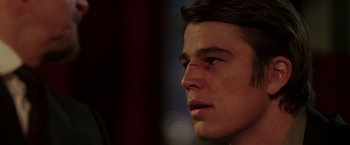 Movie still from “Lucky Number Slevin” (2006), directed by Paul McGuigan – A young man's face with a bruise on his eye; Close Up shot, Over the shoulder angle