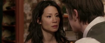 Movie still from “Lucky Number Slevin” (2006), directed by Paul McGuigan – A person with long black hair; Close Up shot, Over the shoulder angle