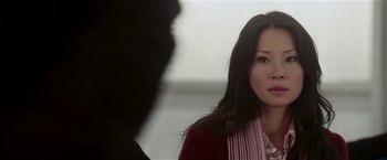 Movie still from “Lucky Number Slevin” (2006), directed by Paul McGuigan – A woman in a red jacket looking at a man in a black suit; Close Up shot, Over the shoulder angle