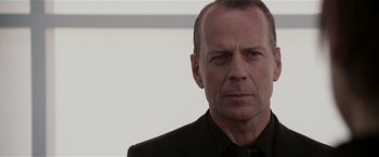 Movie still from “Lucky Number Slevin” (2006), directed by Paul McGuigan – A person wearing a suit and tie; Close Up shot, Low angle