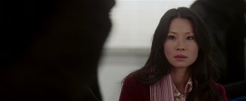 Movie still from “Lucky Number Slevin” (2006), directed by Paul McGuigan – A woman is looking at the camera while a man looks on; Close Up shot, Over the shoulder angle