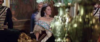 Movie still from “Ludwig” (1973), directed by Luchino Visconti – A woman wearing a tiara and a crown; Medium shot, Over the shoulder angle