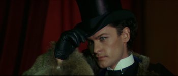 Movie still from “Ludwig” (1973), directed by Luchino Visconti – A person wearing a top hat; Close Up shot, Low angle
