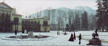 Movie still from “Ludwig” (1973), directed by Luchino Visconti – Two people in period clothing walking in the snow; Extreme Wide shot, Low angle