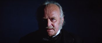Movie still from “Ludwig” (1973), directed by Luchino Visconti – An old man with a mustache wearing a black suit; Close Up shot, Low angle