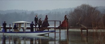 Movie still from “Ludwig” (1973), directed by Luchino Visconti – A group of people standing on top of a wooden dock; Wide shot, High angle