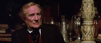 Movie still from “Ludwig” (1973), directed by Luchino Visconti – An older man wearing a suit and tie; Close Up shot, Low angle