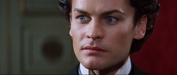 Movie still from “Ludwig” (1973), directed by Luchino Visconti – A person wearing a suit and tie; Close Up shot, High angle