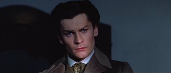 Movie still from “Ludwig” (1973), directed by Luchino Visconti – A person wearing a suit and tie; Close Up shot, High angle