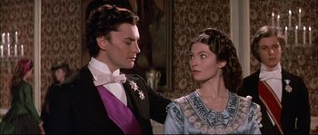 Movie still from “Ludwig” (1973), directed by Luchino Visconti – A man and a woman standing next to each other; Close Up shot, Over the shoulder angle