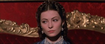Movie still from “Ludwig” (1973), directed by Luchino Visconti – A person wearing a dress; Close Up shot, Over the shoulder angle
