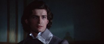 Movie still from “Ludwig” (1973), directed by Luchino Visconti – A person wearing a suit and tie; Close Up shot, Over the shoulder angle