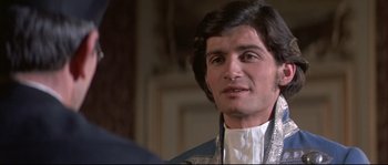 Movie still from “Ludwig” (1973), directed by Luchino Visconti – A person wearing a suit and tie; Close Up shot, Over the shoulder angle