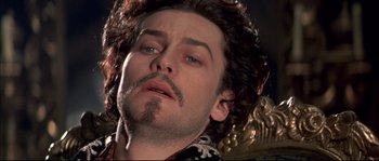 Movie still from “Ludwig” (1973), directed by Luchino Visconti – A person with a beard and mustache; Close Up shot, Low angle