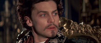 Movie still from “Ludwig” (1973), directed by Luchino Visconti – A person wearing a mask; Close Up shot, High angle