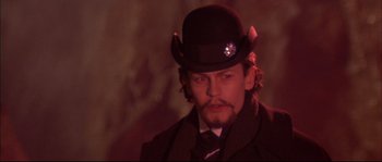 Movie still from “Ludwig” (1973), directed by Luchino Visconti – A person wearing a hat; Close Up shot, Low angle