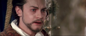 Movie still from “Ludwig” (1973), directed by Luchino Visconti – A person with a beard and mustache; Close Up shot, Over the shoulder angle