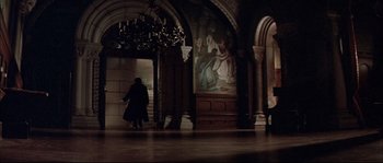 Movie still from “Ludwig” (1973), directed by Luchino Visconti – A woman walking down a staircase in a building; Extreme Wide shot, High angle