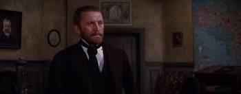 Movie still from “Lust for Life” (1956), directed by George Cukor – A man wearing a suit and a black tie; Close Up shot, Low angle