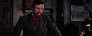 Movie still from “Lust for Life” (1956), directed by George Cukor – A man with a beard and a suit and tie; Close Up shot, Over the shoulder angle