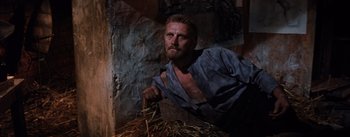 Movie still from “Lust for Life” (1956), directed by George Cukor – A man with a bunch of hay in his hands; Medium shot, High angle
