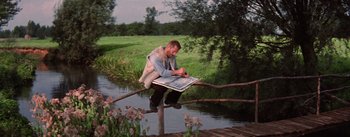 Movie still from “Lust for Life” (1956), directed by George Cukor – A man sitting on top of a tree branch; Wide shot, High angle