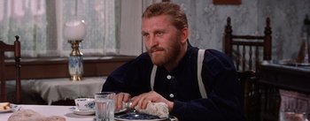 Movie still from “Lust for Life” (1956), directed by George Cukor – A man sitting at a table with a plate in front of him; Close Up shot, Over the shoulder angle