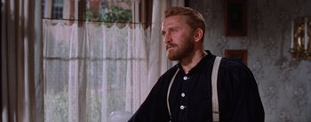 Movie still from “Lust for Life” (1956), directed by George Cukor – A man sitting in a chair in front of a window; Medium shot, Over the shoulder angle