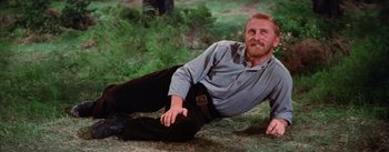 Movie still from “Lust for Life” (1956), directed by George Cukor – A man laying on the ground in the grass; Medium shot, High angle