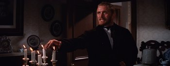 Movie still from “Lust for Life” (1956), directed by George Cukor – A man holding a candle in a dark room; Medium shot, Over the shoulder angle