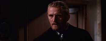 Movie still from “Lust for Life” (1956), directed by George Cukor – A person wearing a suit and tie; Close Up shot, Over the shoulder angle