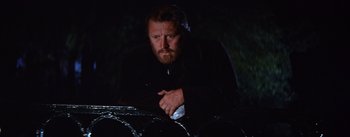Movie still from “Lust for Life” (1956), directed by George Cukor – A man with a goatee and beard leaning on a car; Medium shot, Low angle